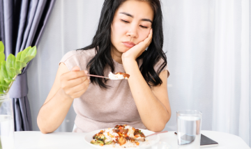 Adult looking at food not interested in eating