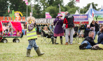 Child wearing ear defenders at festival