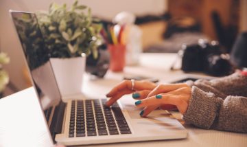 woman typing on laptop