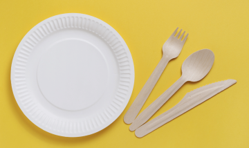 paper plate and cutlery on yellow background